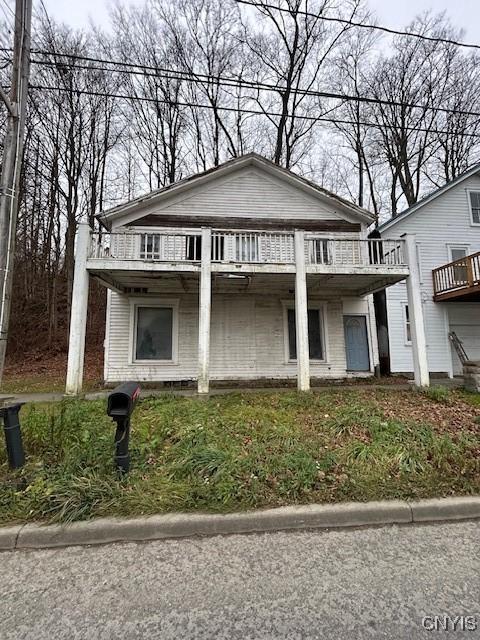 view of front of house with a balcony