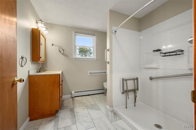 bathroom with vanity, a shower, toilet, and baseboard heating