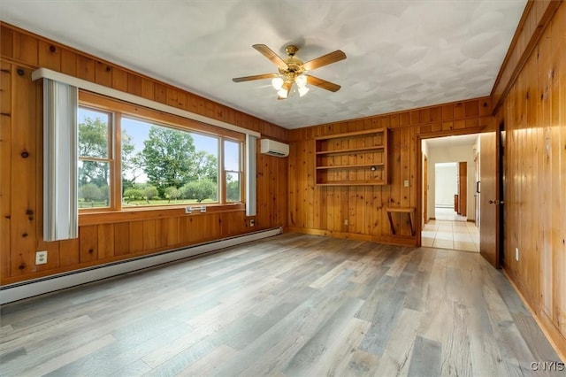 interior space featuring a wall mounted air conditioner, light hardwood / wood-style flooring, baseboard heating, and wooden walls