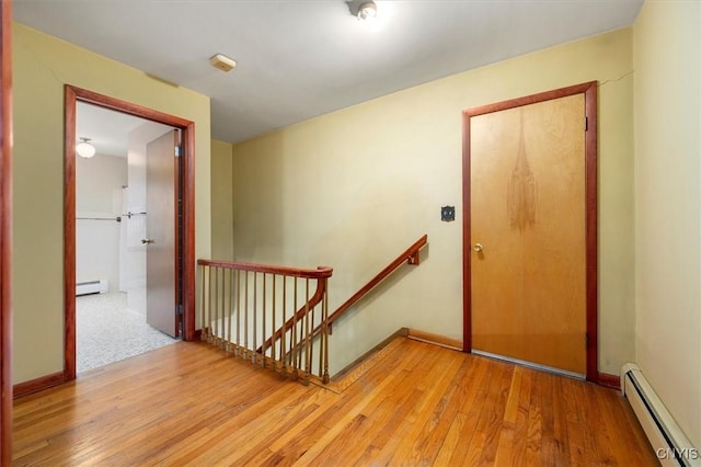 interior space featuring hardwood / wood-style flooring and a baseboard heating unit