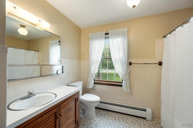 bathroom featuring tile patterned flooring, vanity, a baseboard radiator, and tile walls