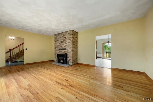 unfurnished living room featuring light hardwood / wood-style floors and a fireplace