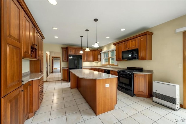 kitchen featuring light stone countertops, hanging light fixtures, light tile patterned floors, a kitchen island, and black appliances