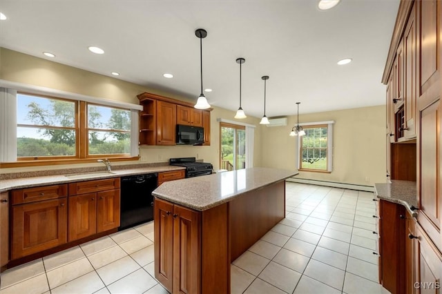 kitchen with plenty of natural light, a kitchen island, black appliances, and decorative light fixtures