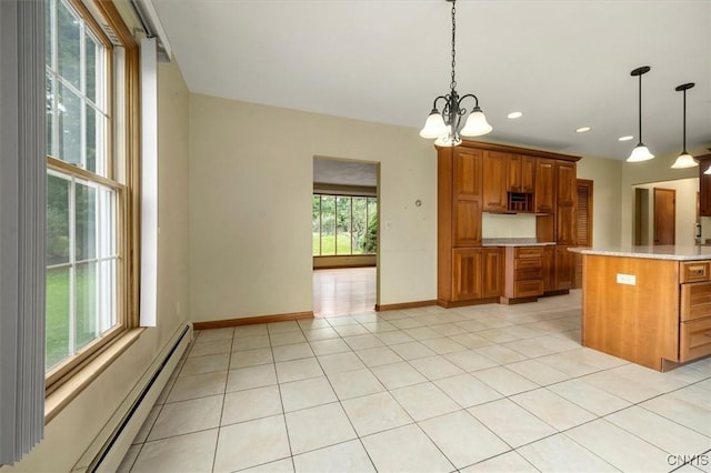 kitchen with pendant lighting, a center island, a baseboard radiator, light tile patterned flooring, and a chandelier