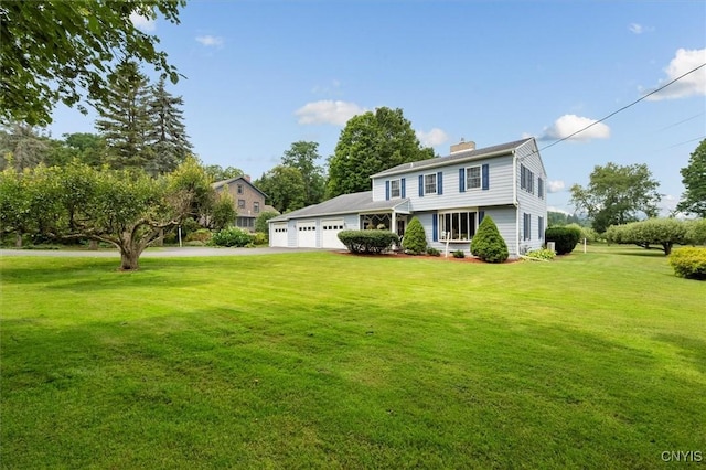 view of front facade with a garage and a front lawn