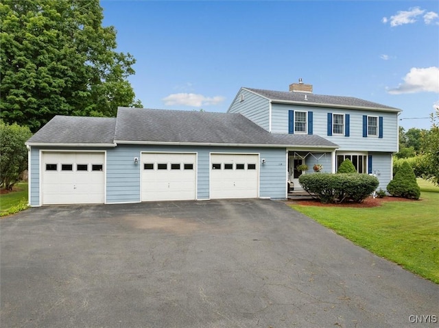 view of property with a garage and a front yard