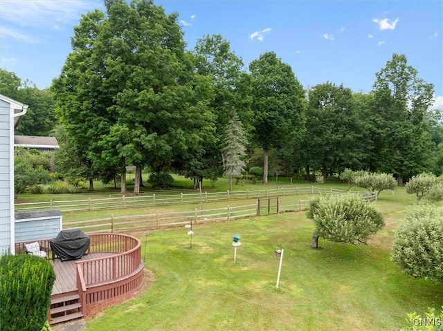 view of yard featuring a rural view and a deck