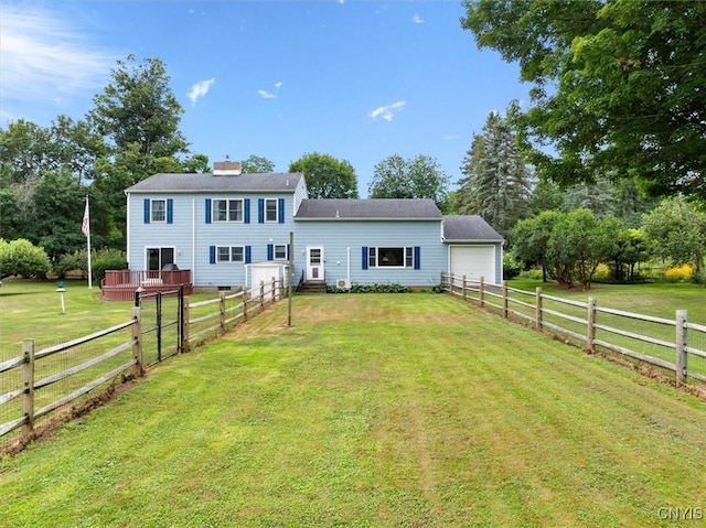 rear view of property with a lawn and a garage