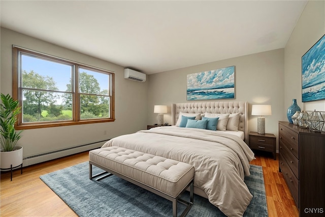 bedroom with baseboard heating, light hardwood / wood-style flooring, and an AC wall unit