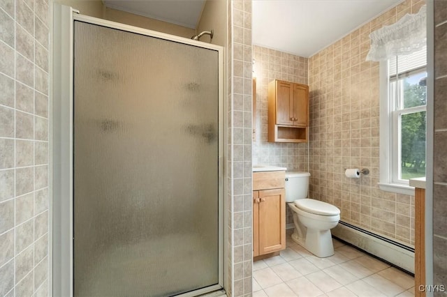 bathroom featuring plenty of natural light, tile walls, and a baseboard heating unit