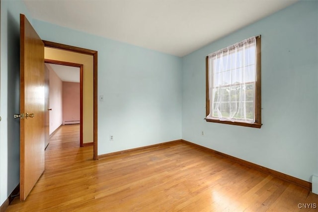 spare room with light hardwood / wood-style floors and a baseboard radiator