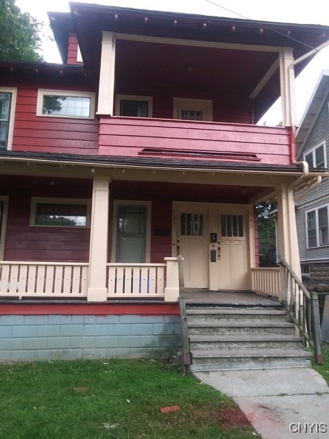 view of front facade featuring a balcony and a porch