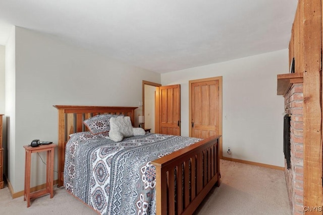 carpeted bedroom featuring a brick fireplace