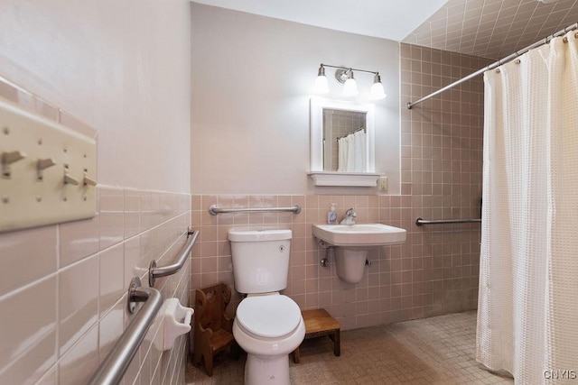 bathroom with tile patterned floors, toilet, tile walls, and walk in shower