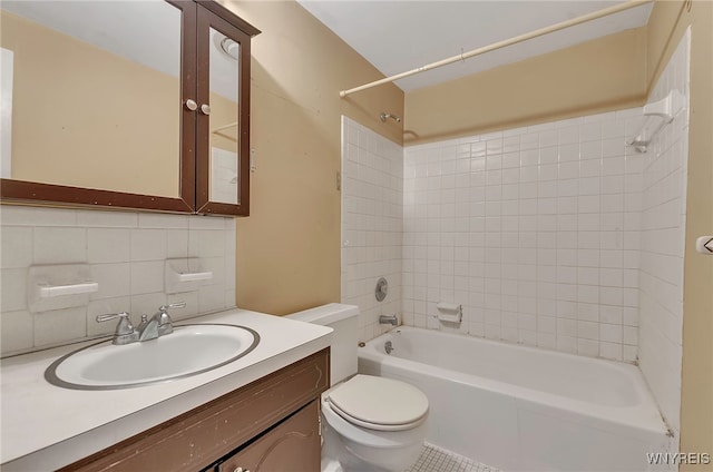 full bathroom with toilet, decorative backsplash, vanity, tile walls, and tiled shower / bath