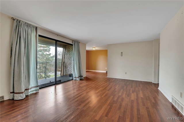 spare room with dark wood-type flooring