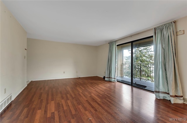 empty room with dark wood-type flooring