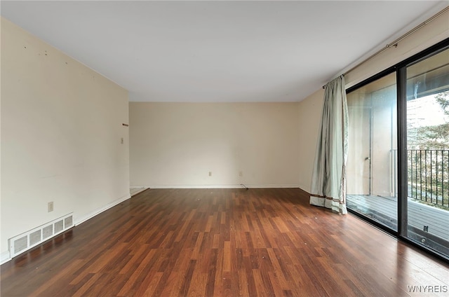 spare room with dark hardwood / wood-style flooring