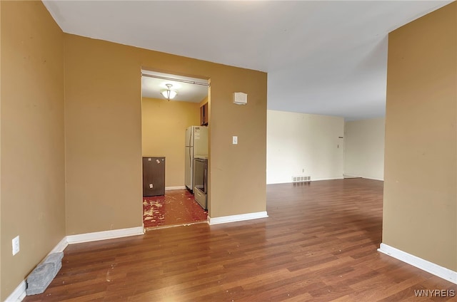 unfurnished room featuring hardwood / wood-style flooring