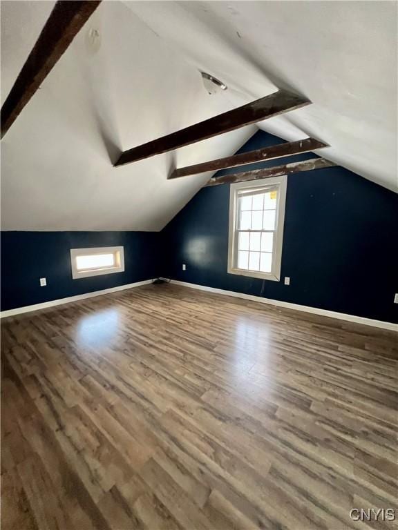 additional living space featuring hardwood / wood-style flooring and lofted ceiling with beams