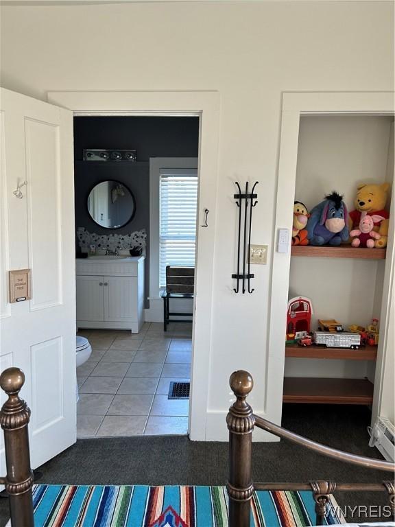 hallway with sink and tile patterned floors