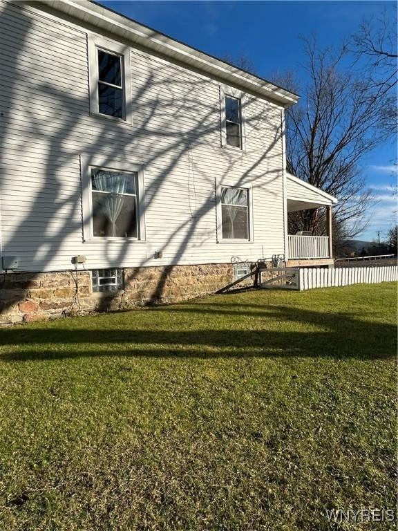 view of side of property with a yard