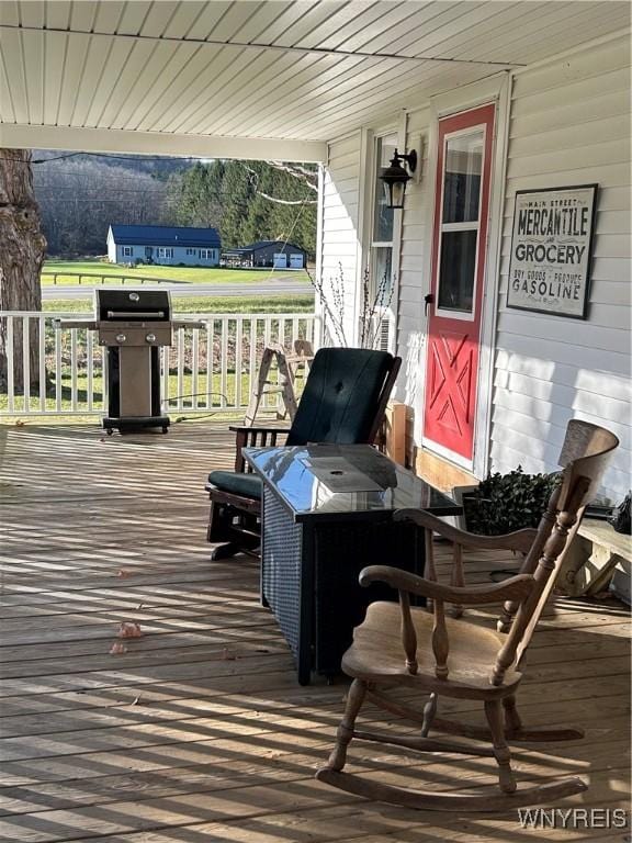 wooden terrace featuring covered porch