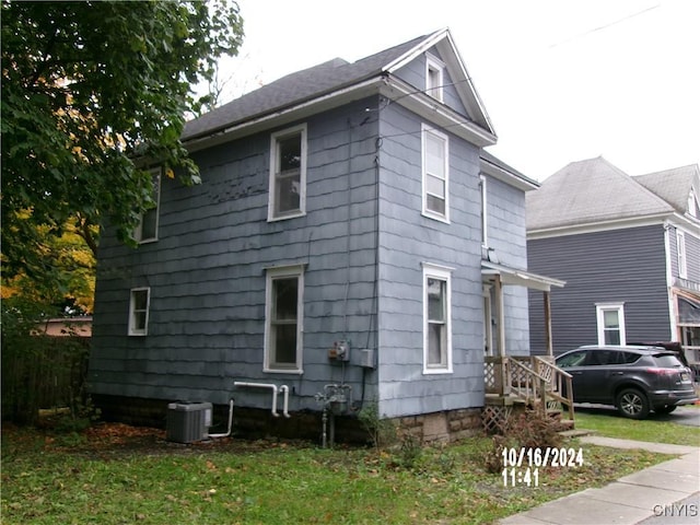 view of side of property featuring central AC unit