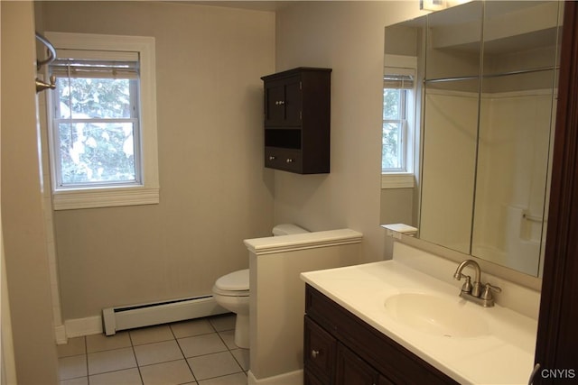 bathroom with a healthy amount of sunlight, vanity, tile patterned floors, and a baseboard heating unit