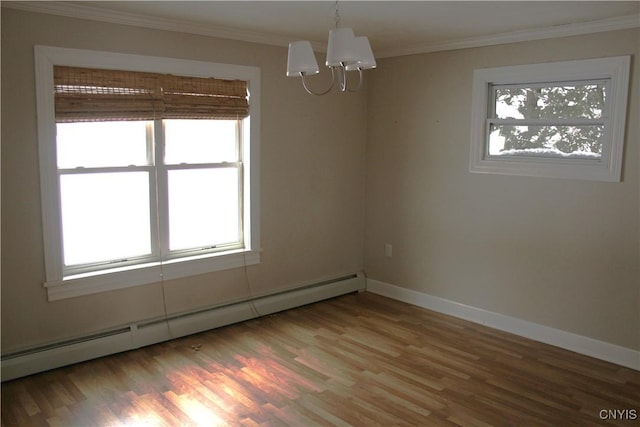 spare room with wood-type flooring, a baseboard radiator, a wealth of natural light, and a notable chandelier