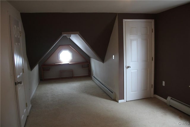 bonus room featuring light colored carpet and a baseboard heating unit