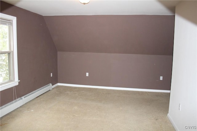 additional living space with baseboard heating, light carpet, and lofted ceiling