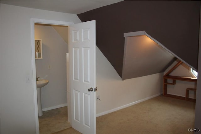 bonus room featuring light carpet and vaulted ceiling