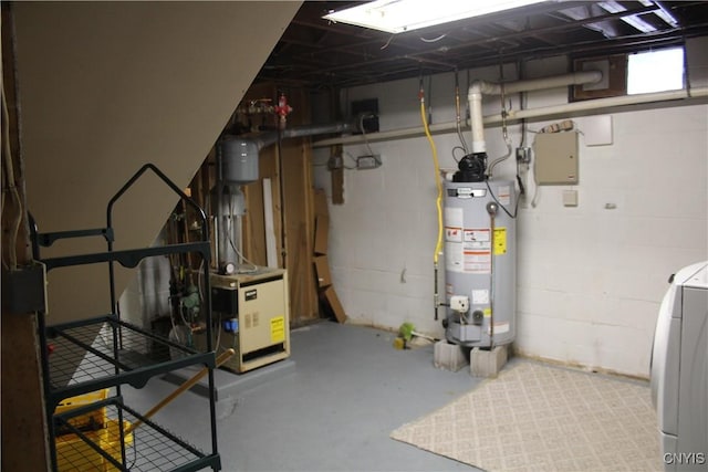 basement featuring water heater and washer / dryer