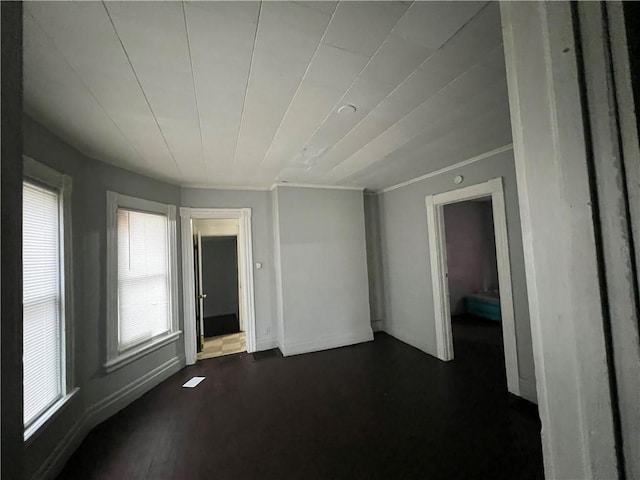 spare room featuring dark hardwood / wood-style flooring and ornamental molding