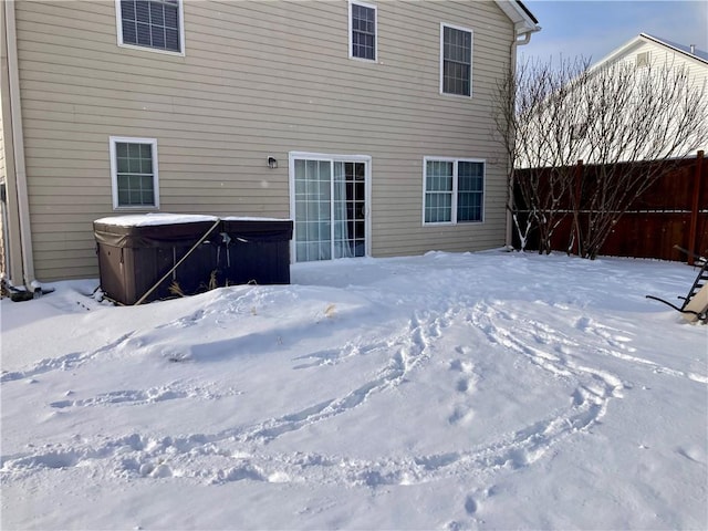 snow covered property featuring a hot tub