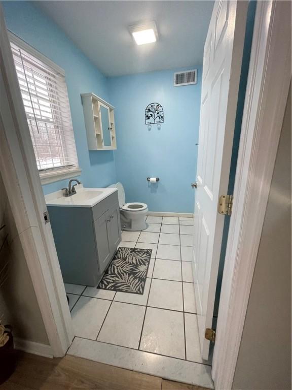 bathroom with tile patterned floors, vanity, and toilet