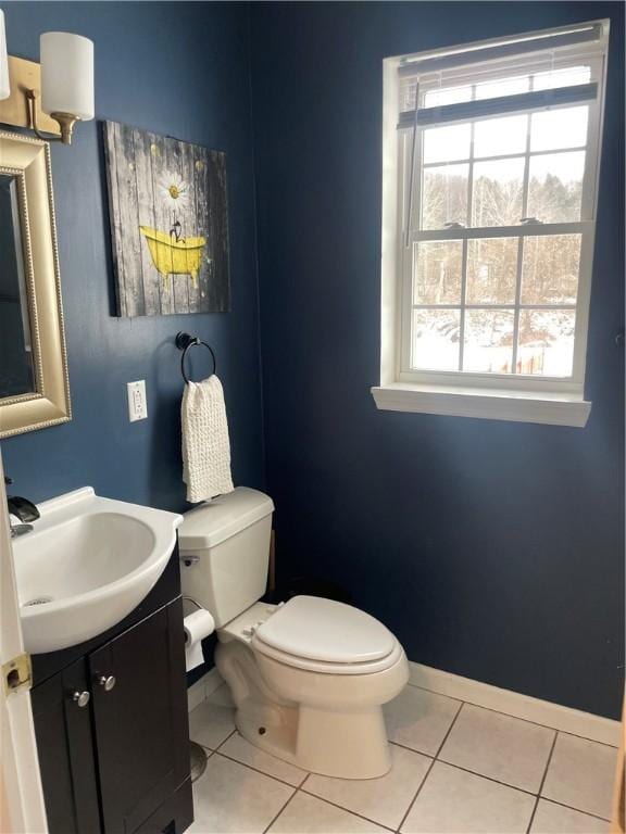 bathroom featuring tile patterned flooring, vanity, and toilet