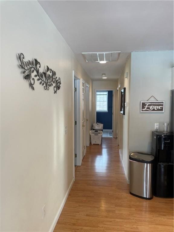 corridor featuring light hardwood / wood-style floors