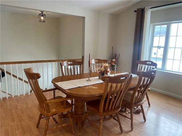 dining space with light hardwood / wood-style floors