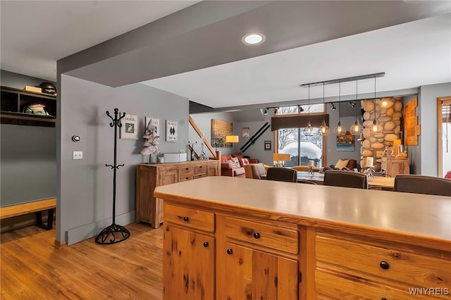 kitchen with pendant lighting and light hardwood / wood-style flooring