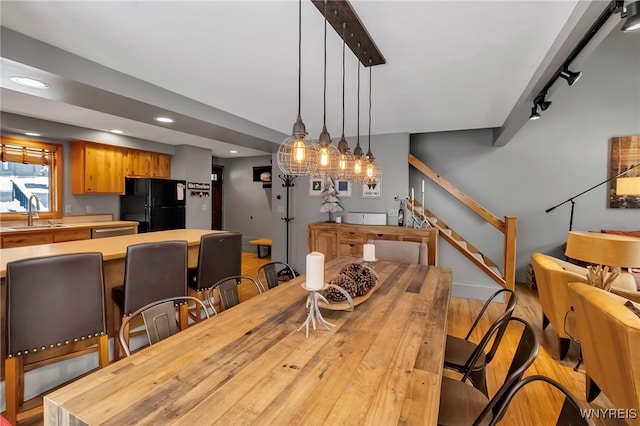 dining room with light wood-type flooring and sink