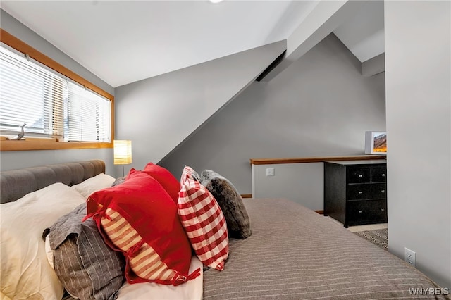 carpeted bedroom featuring lofted ceiling