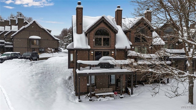 view of snow covered rear of property