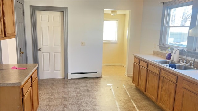 kitchen featuring a baseboard heating unit and sink