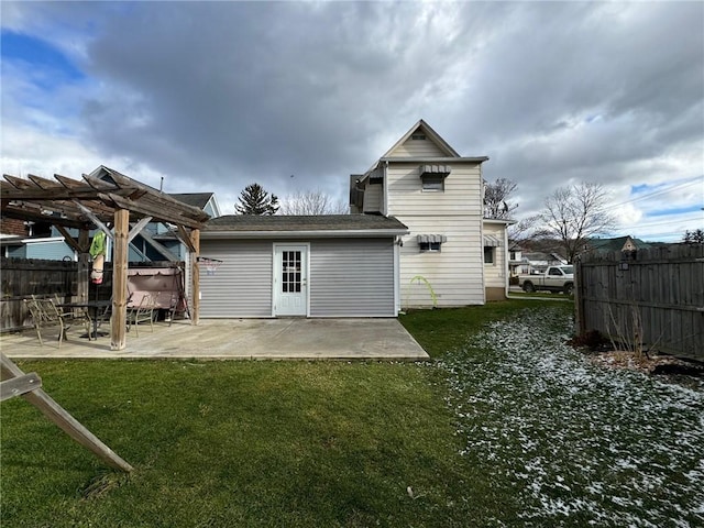 back of house featuring a pergola, a patio area, and a yard