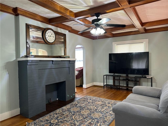 living room with beam ceiling, dark hardwood / wood-style flooring, ceiling fan, and coffered ceiling