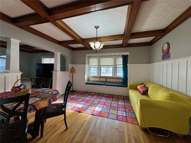 interior space featuring beam ceiling, light hardwood / wood-style flooring, and coffered ceiling