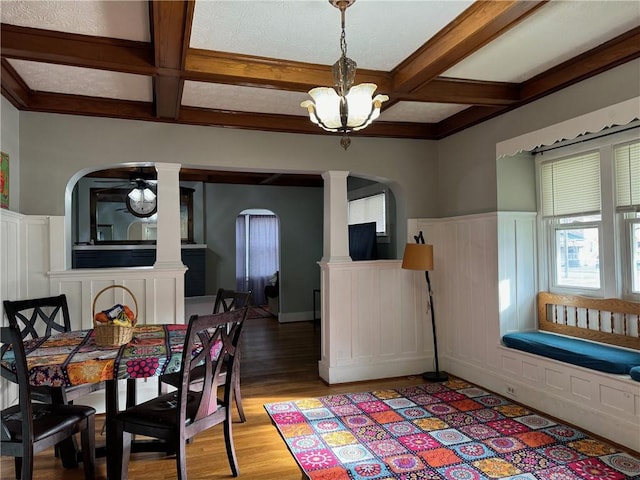 dining space featuring beamed ceiling, a chandelier, light wood-type flooring, and coffered ceiling